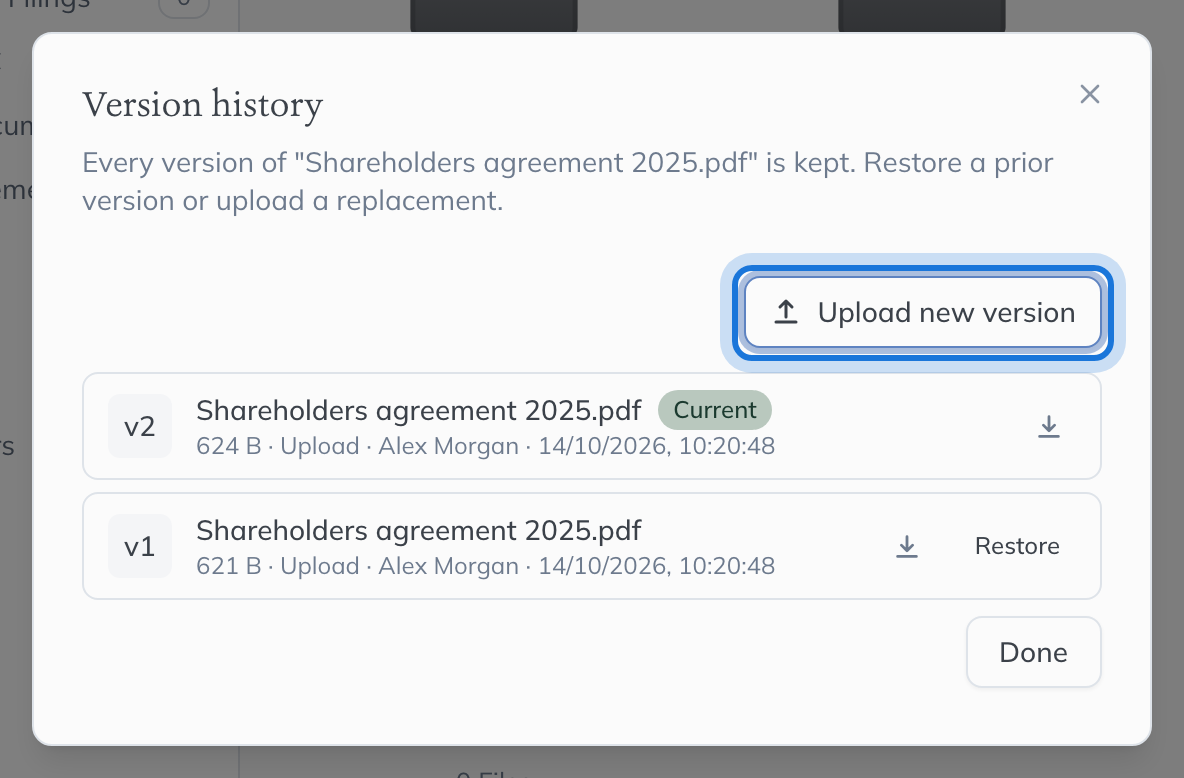 The Version history dialog listing version 2, marked Current, above version 1 with its Restore button, and Upload new version highlighted.