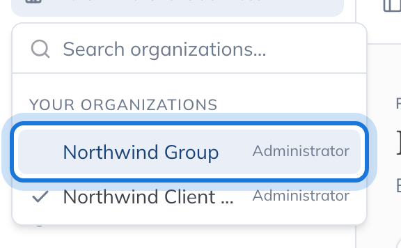 The organisation switcher open, listing your organisations with your role in each and a tick against the one you are in.