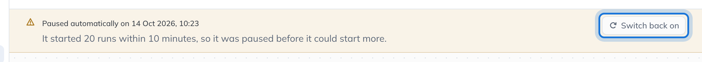 The notice at the top of a paused workflow saying when and why it was paused, with Switch back on highlighted.